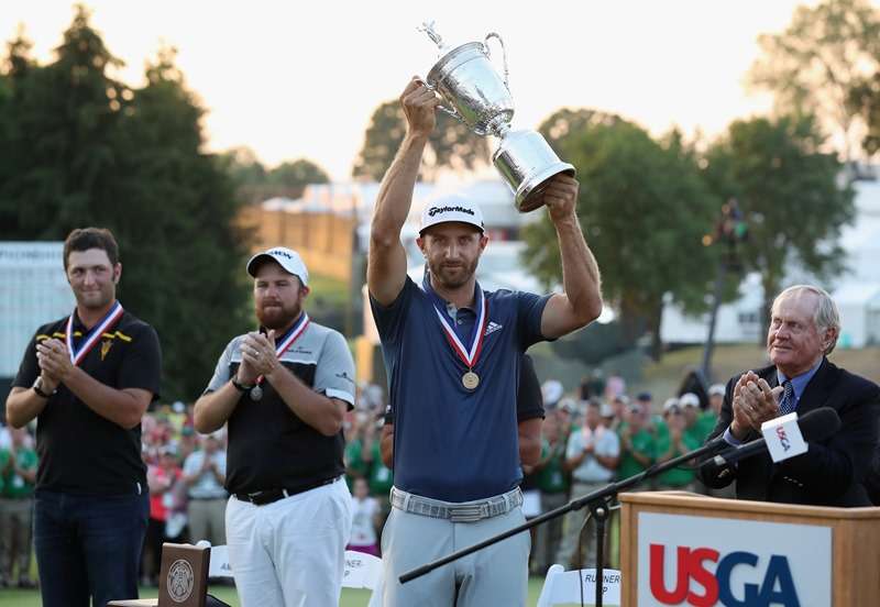 Duck broken: Dustin Johnson lifts the US Open trophy, his first  Major title (photo by Getty Images)