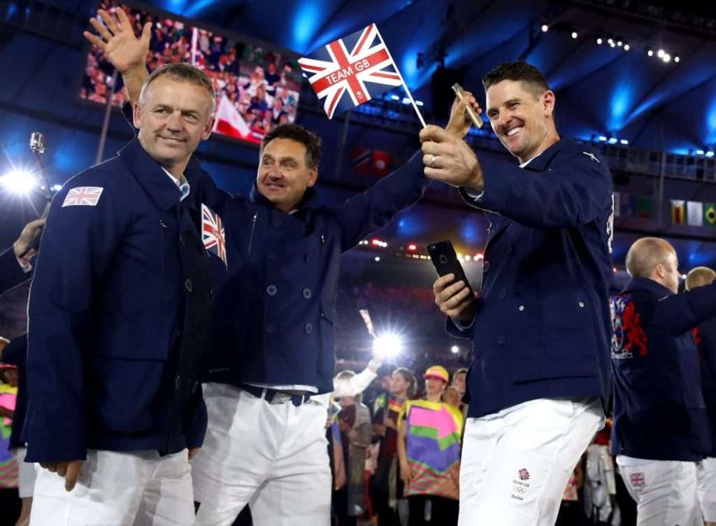 Ceremonial start: Justin Rose, right, caddie Mark Futcher and team manager Jamie Spence, left, enjoy the opening to the games