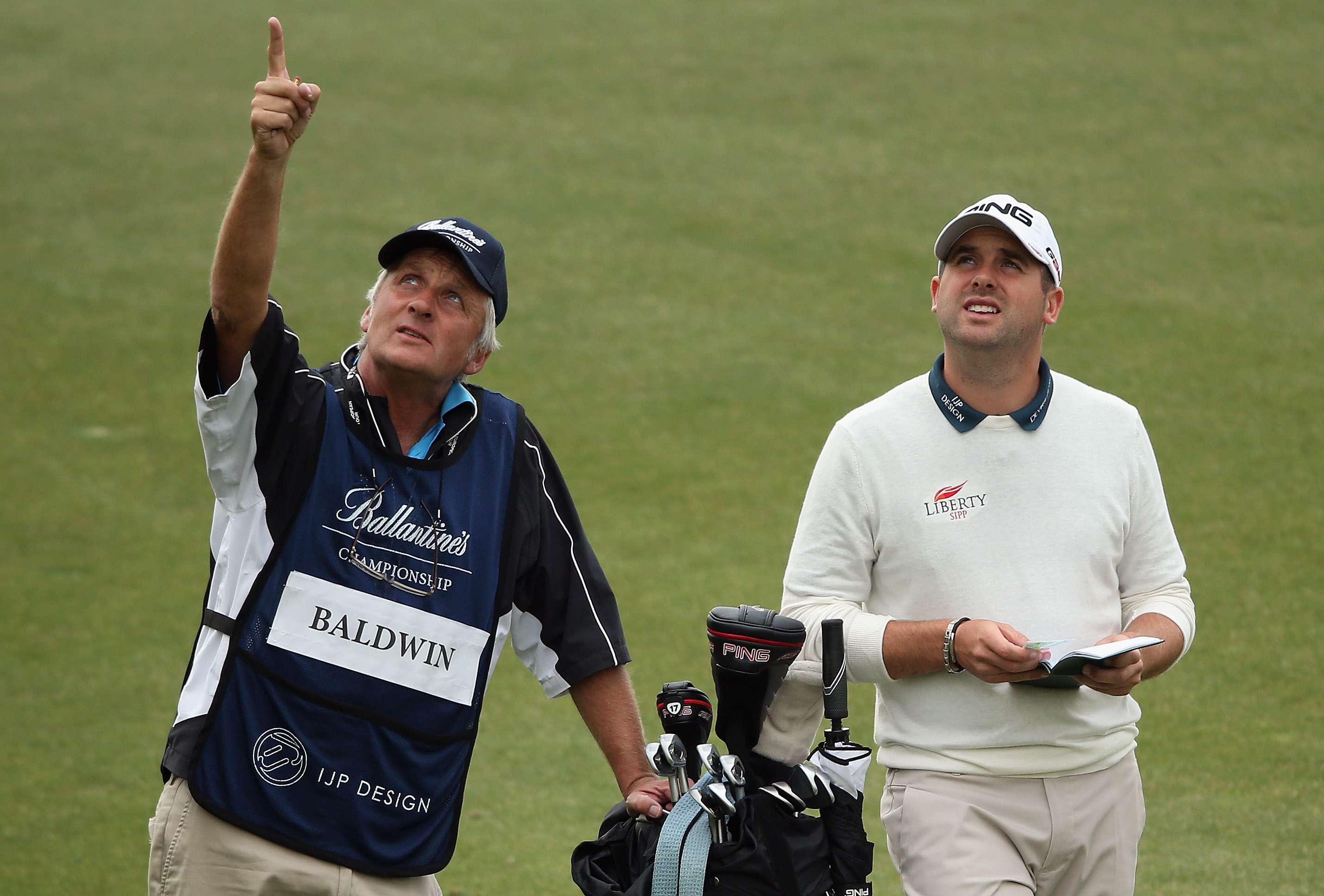 Forecasting: Matthew Baldwin, right, and Julian Phillips consider the weather as the Ballantine's Championship gets underway (Photo by Andrew Redington/Getty Images)
