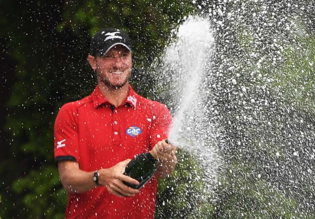 Breakthrough: Chris Wood celebrates the biggest win of his career, in the BMW Championship at Wentworth (photo by Getty Images)
